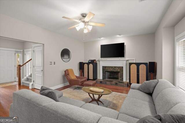 2995 Boulder Walk Ct SE, Atlanta, GA 30316 - living room with stairs, wood finished floors, ceiling fan, baseboards, and a fireplace with raised hearth