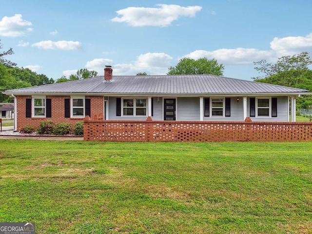 single story home with covered porch, a chimney, and metal roof