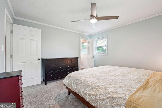 bedroom featuring ornamental molding, a ceiling fan, and carpet floors