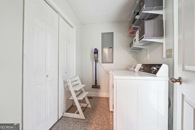 washroom with washing machine and clothes dryer, electric panel, laundry area, and baseboards