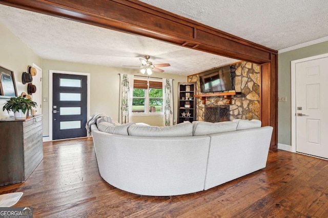 living room with dark wood-style floors, a textured ceiling, ceiling fan, and baseboards
