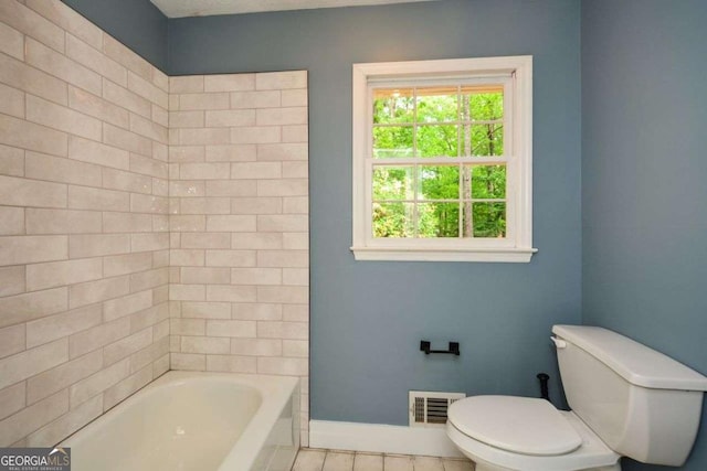 bathroom featuring toilet, tile patterned flooring, visible vents, and baseboards