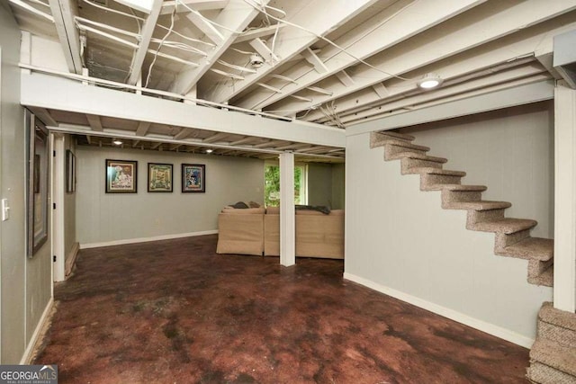 below grade area with stairway and baseboards