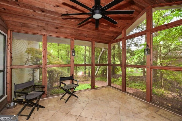 unfurnished sunroom with ceiling fan