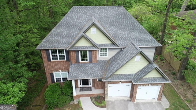 71 Anita Pl SE, Mableton, GA 30126 - view of front facade with brick siding, a shingled roof, a garage, and concrete driveway
