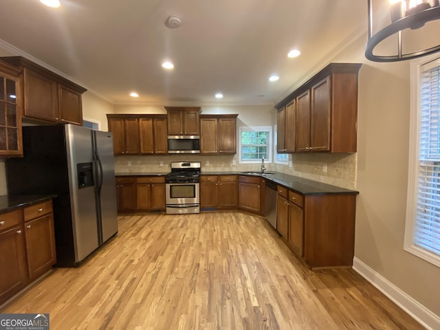 71 Anita Pl SE, Mableton, GA 30126 - kitchen featuring appliances with stainless steel finishes, light wood-type flooring, backsplash, crown molding, and glass insert cabinets