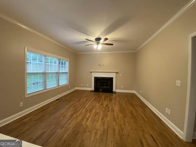 71 Anita Pl SE, Mableton, GA 30126 - unfurnished living room featuring ceiling fan, dark wood finished floors, ornamental molding, and a fireplace with flush hearth