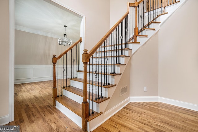 71 Anita Pl SE, Mableton, GA 30126 - stairs featuring a chandelier, wood finished floors, and crown molding