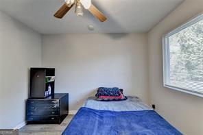 1824 Guardian Way, Lawrenceville, GA 30043 - bedroom featuring ceiling fan, wood finished floors, and baseboards