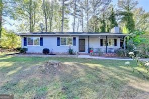 1824 Guardian Way, Lawrenceville, GA 30043 - ranch-style house featuring a porch, a front yard, and a chimney