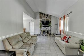 1824 Guardian Way, Lawrenceville, GA 30043 - living area with a fireplace and vaulted ceiling