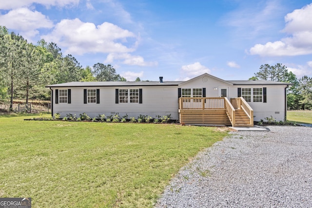 manufactured / mobile home with a front lawn, a wooden deck, and crawl space