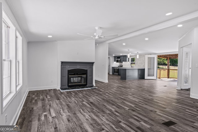 unfurnished living room with recessed lighting, dark wood-style flooring, ceiling fan, a glass covered fireplace, and visible vents