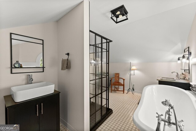 19 Oak Creek Cir, Toccoa, GA 30577 - full bath featuring lofted ceiling, a soaking tub, a sink, baseboards, and two vanities