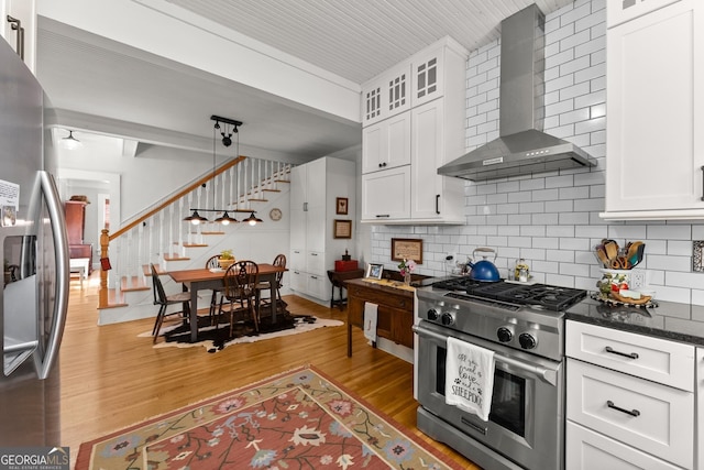 19 Oak Creek Cir, Toccoa, GA 30577 - kitchen with appliances with stainless steel finishes, light wood-style floors, tasteful backsplash, and wall chimney exhaust hood