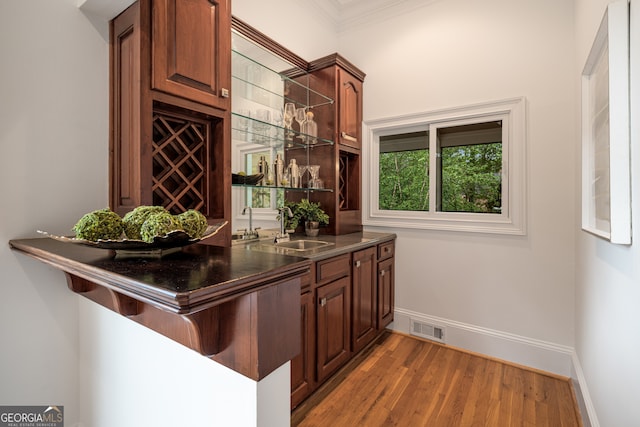 8345 Jett Ferry Rd, Sandy Springs, GA 30350 - bar area featuring crown molding and light wood finished floors