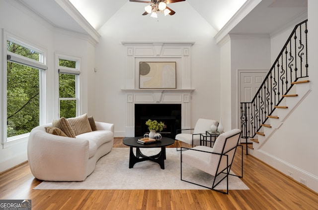 8345 Jett Ferry Rd, Sandy Springs, GA 30350 - living room featuring ceiling fan, stairs, a fireplace with flush hearth, wood finished floors, and high vaulted ceiling