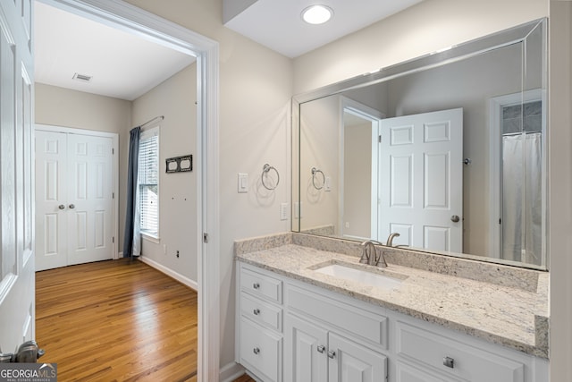 8345 Jett Ferry Rd, Sandy Springs, GA 30350 - full bath featuring vanity and wood finished floors