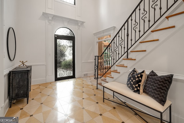 8345 Jett Ferry Rd, Sandy Springs, GA 30350 - entrance foyer with plenty of natural light, a high ceiling, and stairway