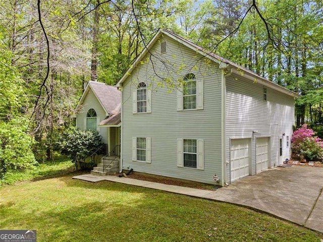 3420 Honeysuckle Ln, Lithia Springs, GA 30122 - view of home's exterior featuring a garage, driveway, and a yard