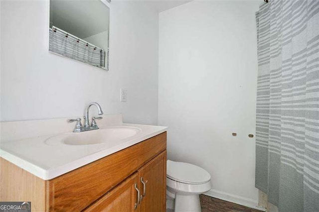 3420 Honeysuckle Ln, Lithia Springs, GA 30122 - bathroom featuring baseboards, a shower with shower curtain, toilet, and vanity