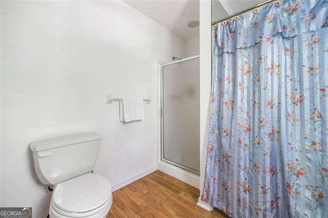 3420 Honeysuckle Ln, Lithia Springs, GA 30122 - full bath with baseboards, a stall shower, toilet, and wood finished floors