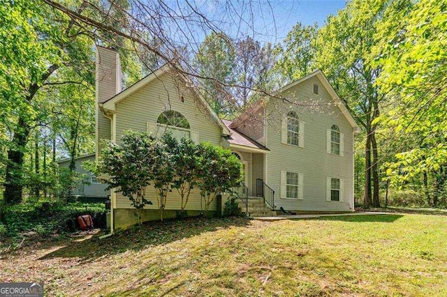 3420 Honeysuckle Ln, Lithia Springs, GA 30122 - view of front of property featuring a chimney and a front yard
