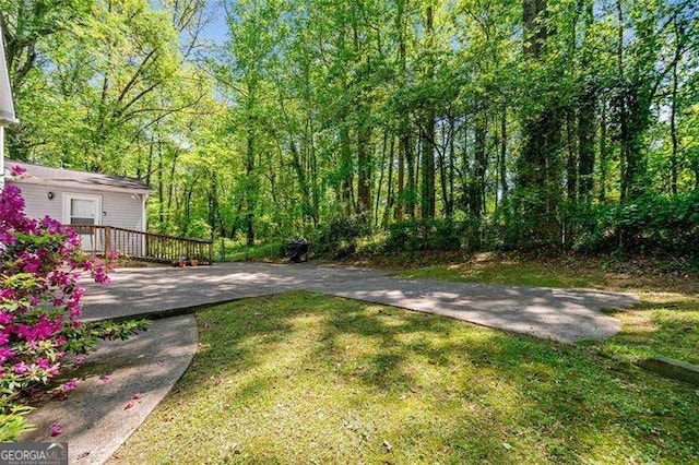 3420 Honeysuckle Ln, Lithia Springs, GA 30122 - view of yard with a deck and a wooded view