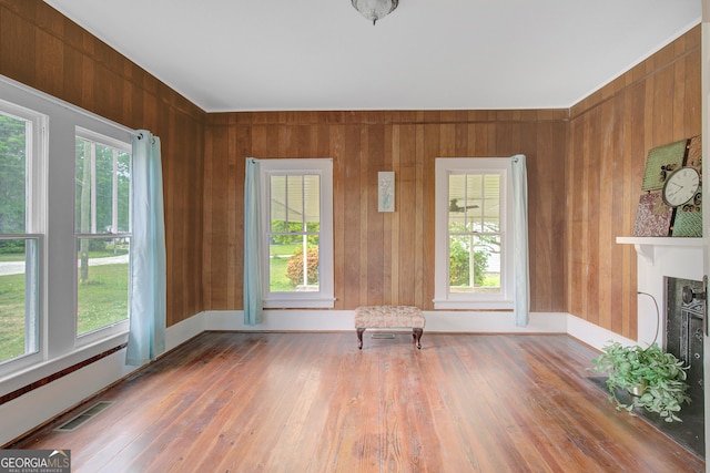 48 Roseview Dr, Concord, GA 30206 - unfurnished living room with wood walls, visible vents, and hardwood / wood-style flooring