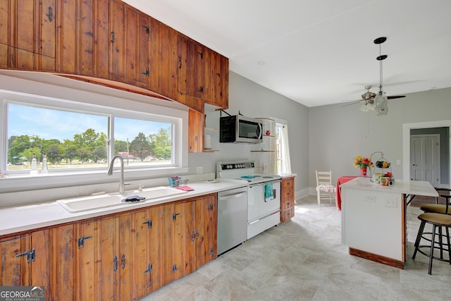 48 Roseview Dr, Concord, GA 30206 - kitchen with a sink, brown cabinets, stainless steel appliances, a breakfast bar, and light countertops