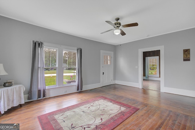 48 Roseview Dr, Concord, GA 30206 - unfurnished living room with wood finished floors, ceiling fan, and baseboards