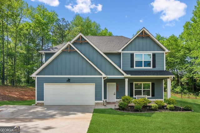 craftsman inspired home with a garage, a front lawn, a shingled roof, and concrete driveway