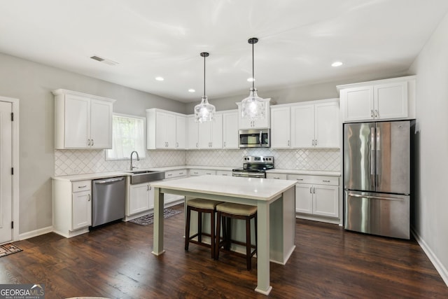 kitchen with visible vents, stainless steel appliances, light countertops, and white cabinets