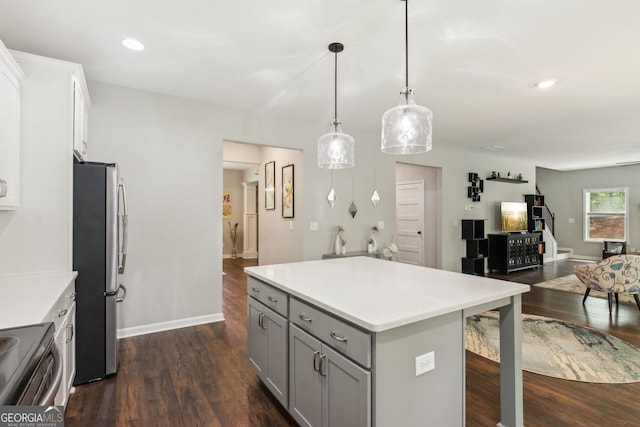 kitchen featuring dark wood-style floors, gray cabinetry, open floor plan, and stainless steel appliances