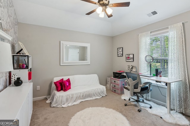 carpeted office space with visible vents and ceiling fan