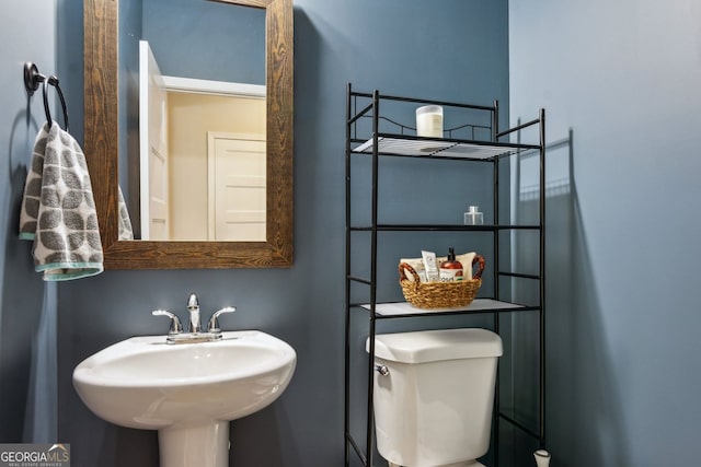 bathroom with toilet and a sink