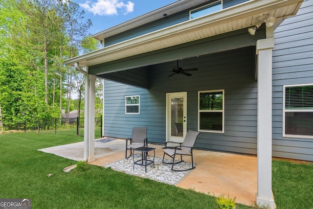 view of patio / terrace with fence and a ceiling fan