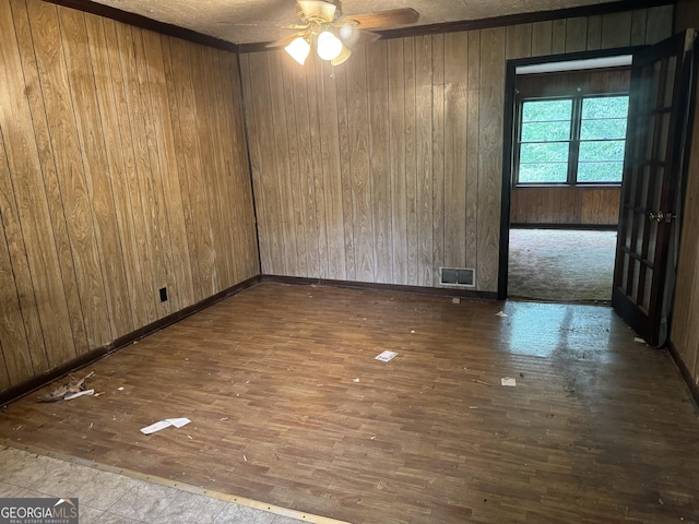 343 Academy Dr, Dallas, GA 30132 - empty room featuring wood-type flooring, a ceiling fan, visible vents, and wood walls