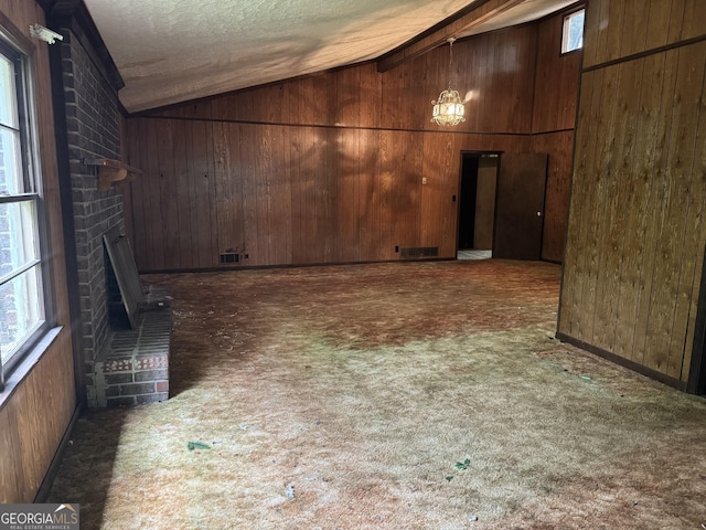 343 Academy Dr, Dallas, GA 30132 - basement with wooden walls, a fireplace, a textured ceiling, carpet, and visible vents