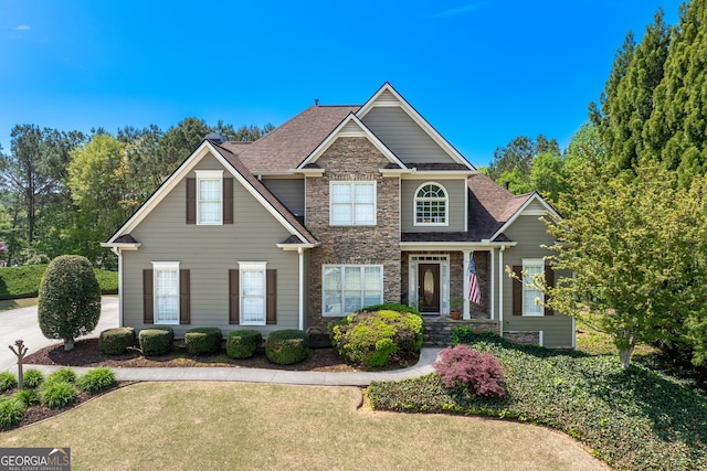 9255 Old Preserve Trl, Ball Ground, GA 30107 - view of front facade with stone siding, a front lawn, and roof with shingles