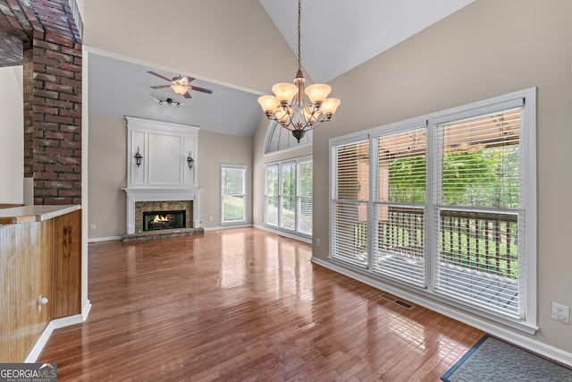 9255 Old Preserve Trl, Ball Ground, GA 30107 - unfurnished living room featuring wood finished floors, a chandelier, a fireplace, high vaulted ceiling, and ceiling fan