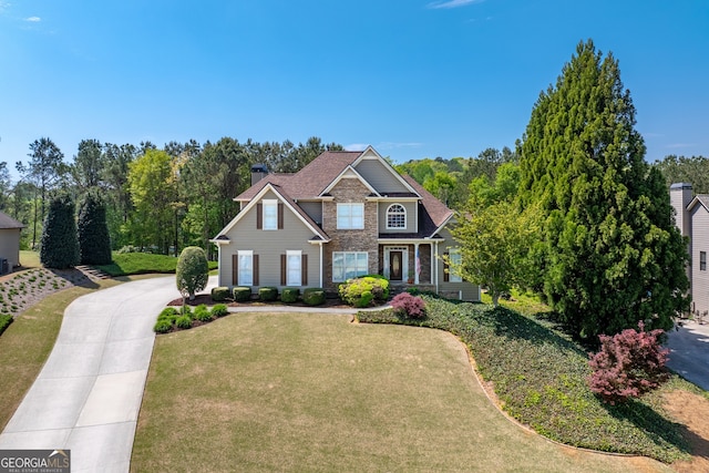 9255 Old Preserve Trl, Ball Ground, GA 30107 - view of front of property with a front yard, driveway, stone siding, and a chimney