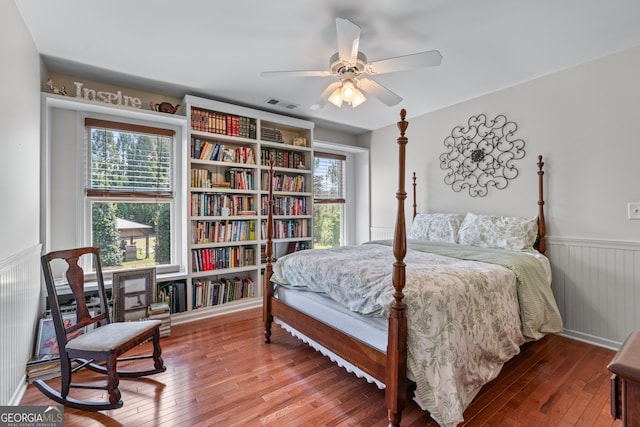 9255 Old Preserve Trl, Ball Ground, GA 30107 - bedroom with wood-type flooring, wainscoting, and ceiling fan