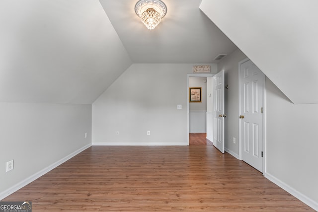 9255 Old Preserve Trl, Ball Ground, GA 30107 - additional living space featuring light wood-style flooring and vaulted ceiling