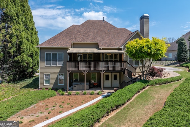 9255 Old Preserve Trl, Ball Ground, GA 30107 - back of house with a hot tub, a wooden deck, a shingled roof, a patio area, and a chimney