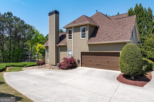 9255 Old Preserve Trl, Ball Ground, GA 30107 - view of front of house featuring a chimney, concrete driveway, and a shingled roof