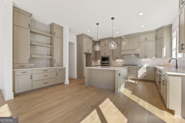 9135 Greenway Ct, Gainesville, GA 30506 - kitchen with a kitchen island, stainless steel appliances, light wood-style floors, decorative backsplash, and recessed lighting