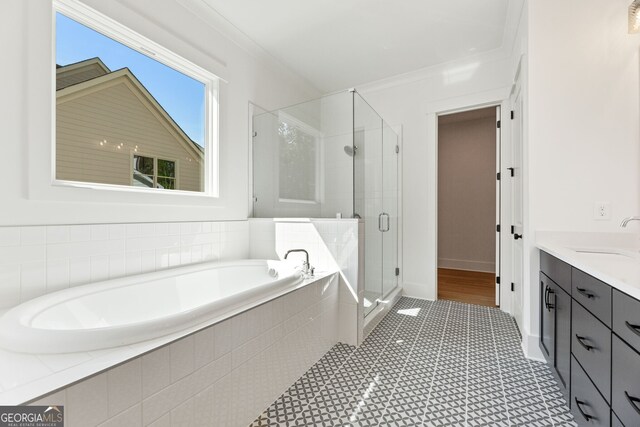 9135 Greenway Ct, Gainesville, GA 30506 - full bathroom featuring a garden tub, a stall shower, double vanity, crown molding, and tile patterned floors