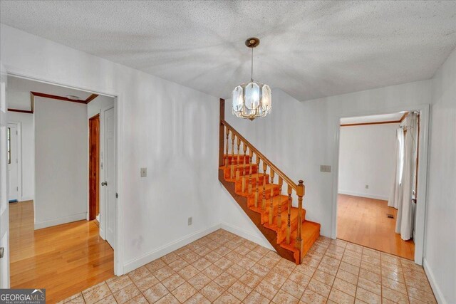208 Earlwood Dr, Dublin, GA 31021 - interior space with a chandelier, baseboards, wood finished floors, and a textured ceiling