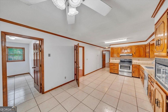 kitchen with light tile patterned floors, appliances with stainless steel finishes, ceiling fan, under cabinet range hood, and ornamental molding